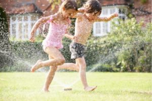 kids playing with the sprinklers